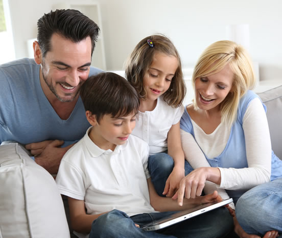 Family of 4 around a tablet